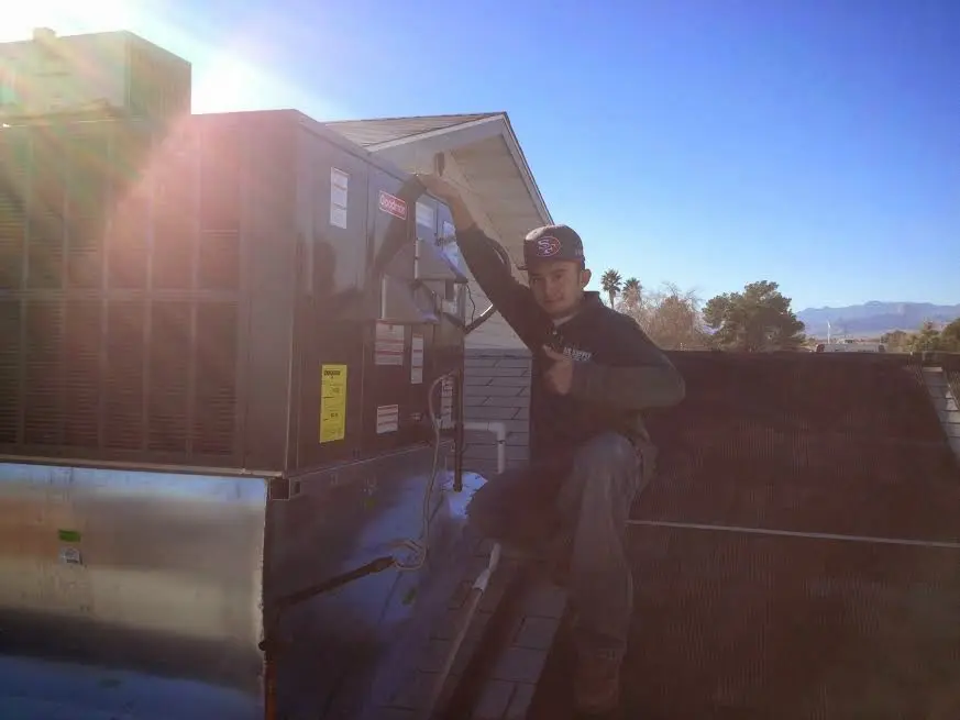 HVAC technician performing HVAC Inspection on a rooftop unit in Fountain Valley